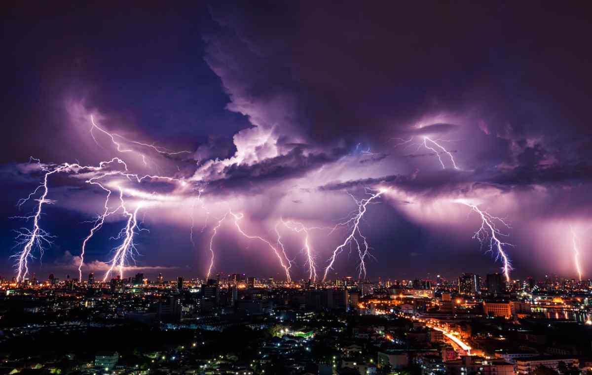 Lightning storm over city in purple light